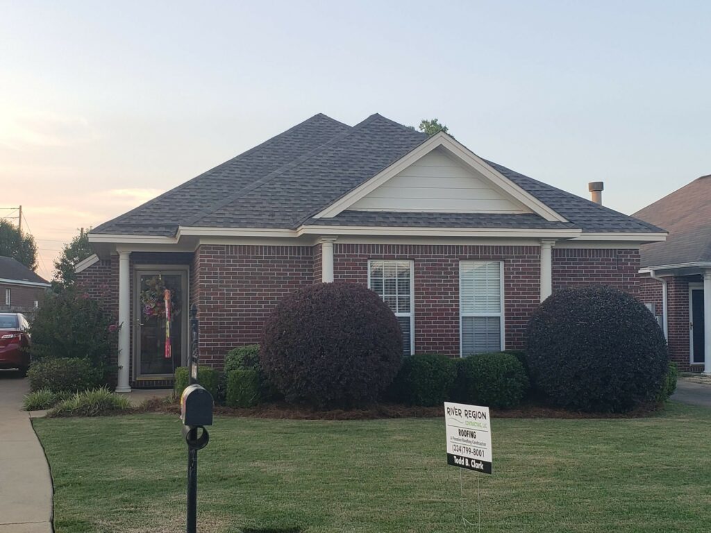 home with asphalt shingles and river region contracting sign in yard