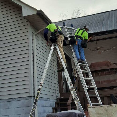 river region contracting employees working on roof of a home