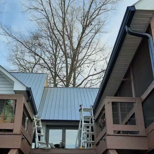 progress of metal roofing and gutter work on a home