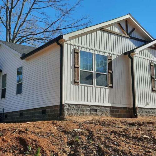 home with gutters and shingle roof