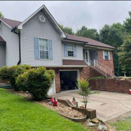 home with shingles on roof and gutters