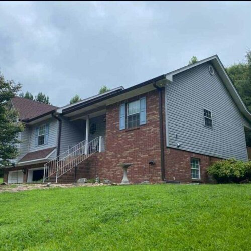 home with shingles on roof and gutters