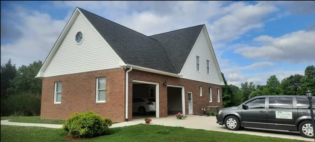 home with asphalt shingles and river region contracting van in driveway