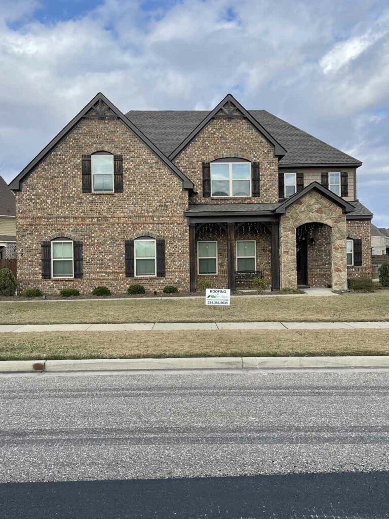 home with asphalt shingle roof and river region contracting sign in yard