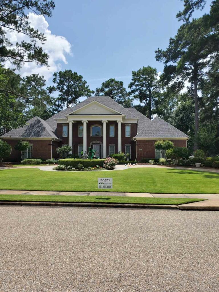 home with asphalt shingle roof and river region contracting sign in yard